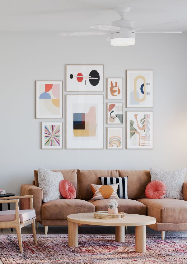 Wixby House A modern living room with a tan sofa, colorful pillows, abstract wall art, and a round wooden coffee table.