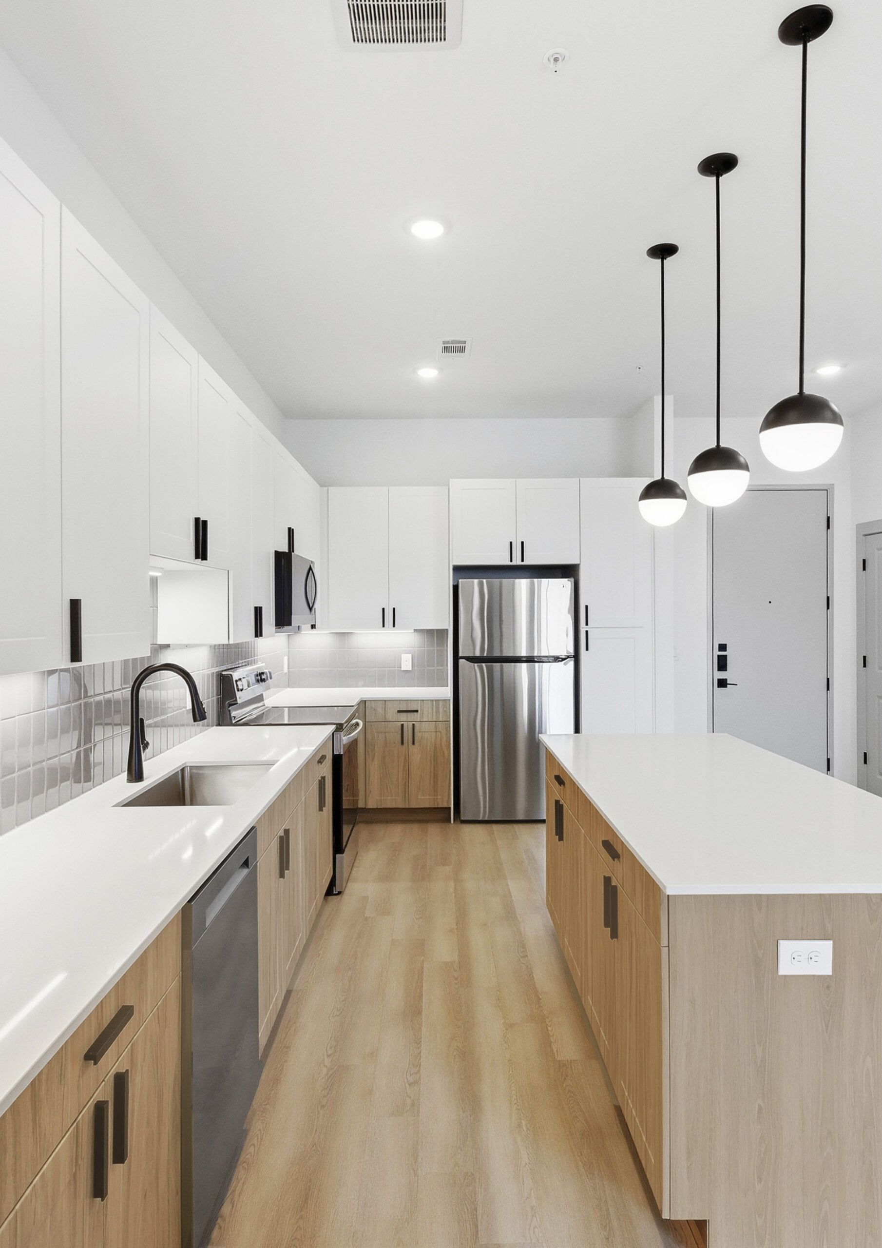 Modern apartment kitchen with quartz countertops and stainless steel appliances in Austin, TX